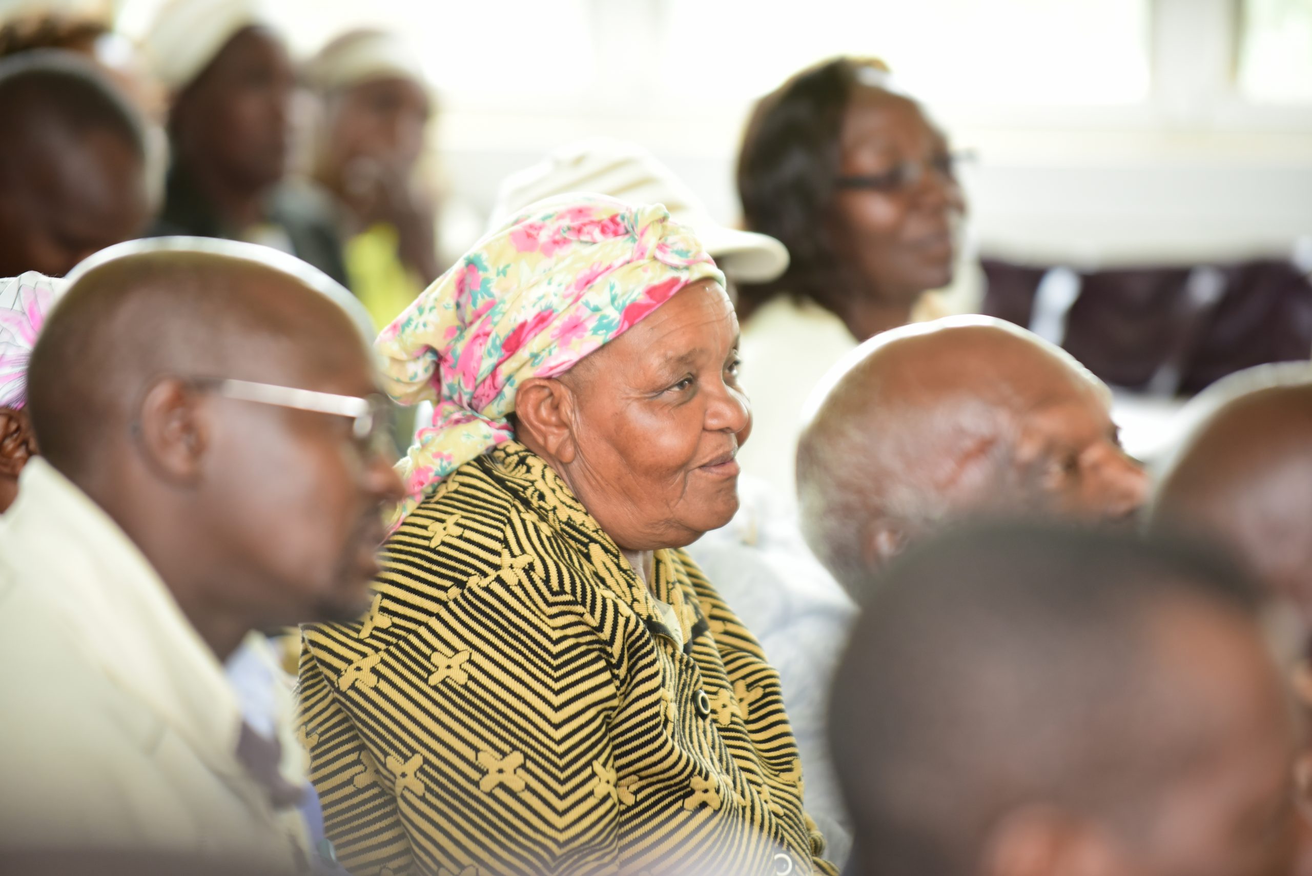 picture of people with old woman in focus