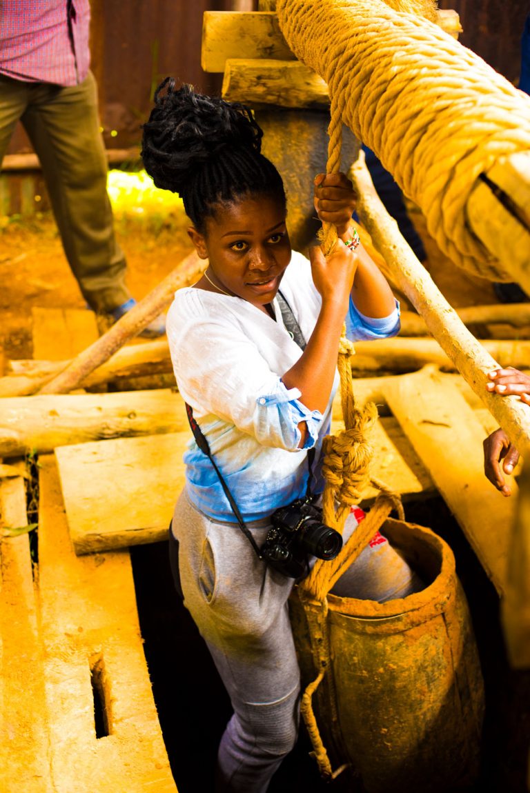 Young lady holds rope while entering a gold mine in Western Kenya