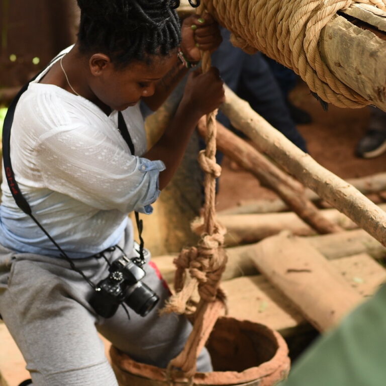 Young lady descending into an underground mine with camera