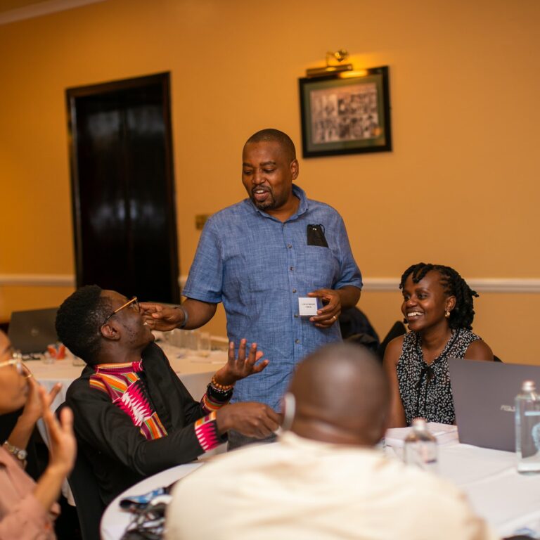 Chief officers and members of OI staff in a group discussion