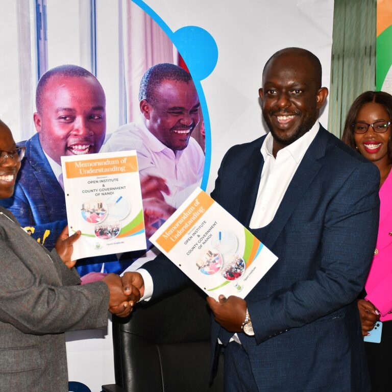 Al Kags and Dr. Yulita Mitei as they exchange signed MOUs